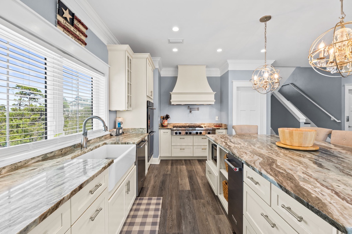 Your gourmet kitchen awaits with marble countertops, premium appliances, and elegant pendant lighting for memorable meal preparations.