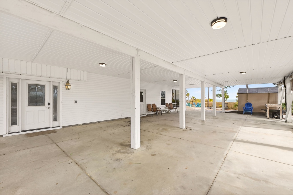 Expansive covered patio with comfortable seating where you'll enjoy morning coffee and evening conversations under the ceiling fans.