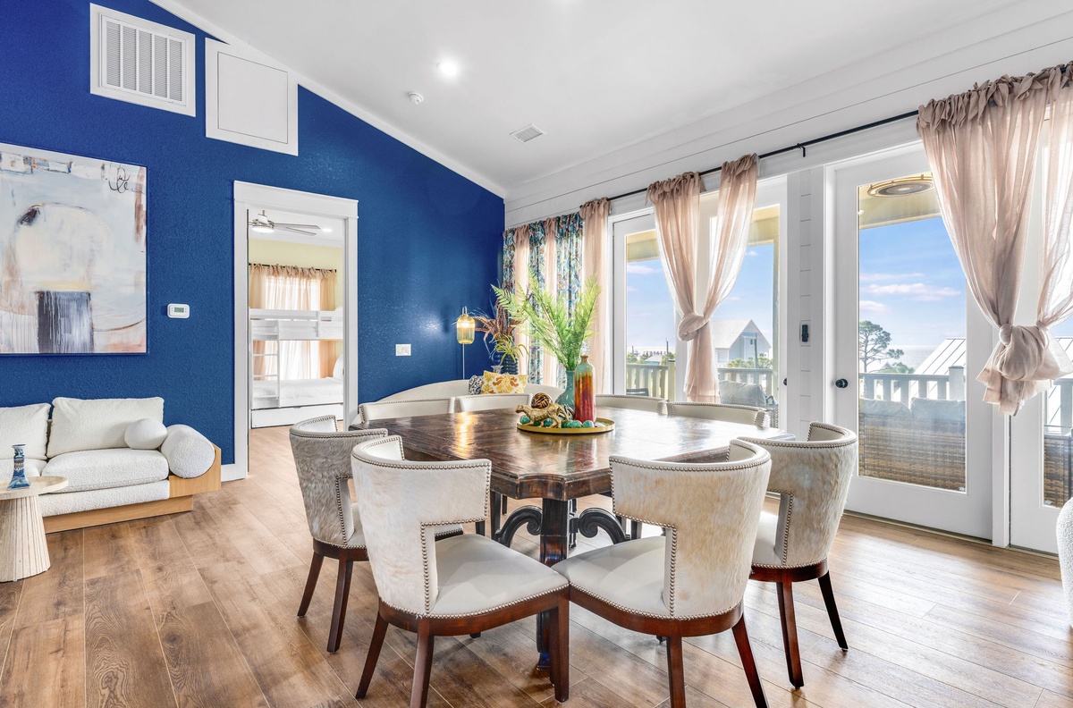 Gather around your elegant dining table where natural light streams through expansive windows, creating the perfect setting for memorable meals.