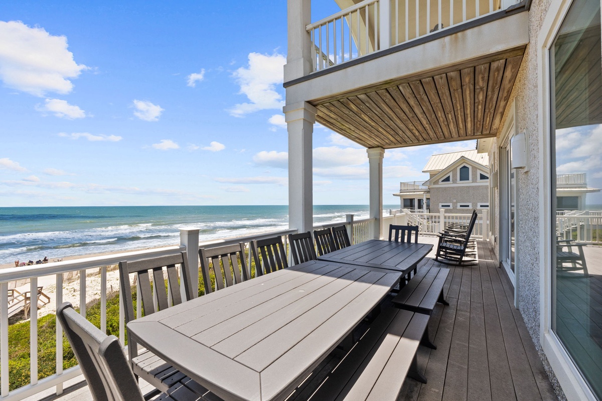 This elevated beachfront deck features oceanfront dining with panoramic sea views, gentle ocean breezes, and the soothing sound of waves. An ideal setting for coastal relaxation and alfresco meals.