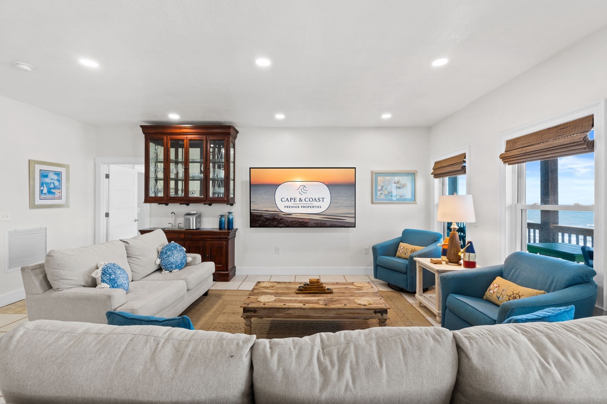 Relax in your spacious living room with ocean views, plush seating, and coastal charm—perfect for unwinding with loved ones after a day at the beach.