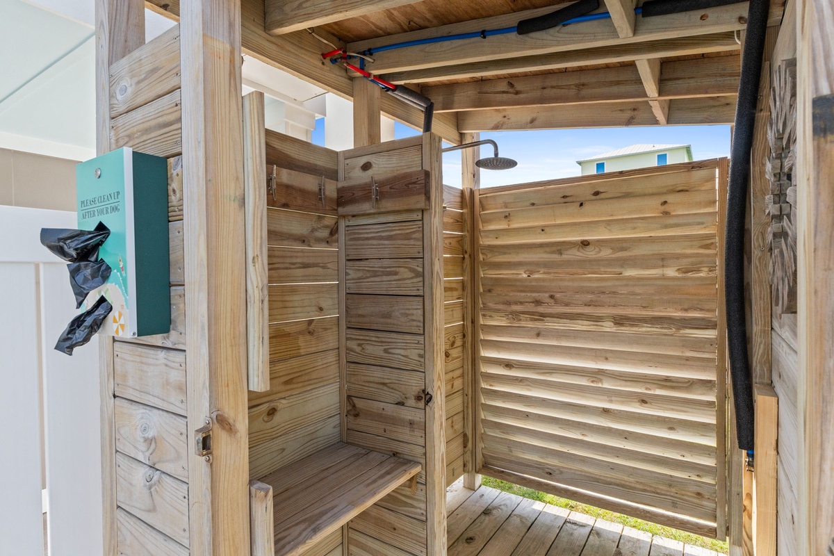 Rinse off under the open sky in your private outdoor shower with warm wood paneling and natural light.