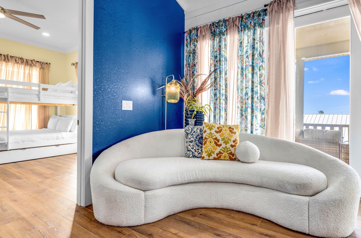 Relax on your curved sofa while watching the ocean through floor-to-ceiling windows, with cozy bunks nearby for restful nights.