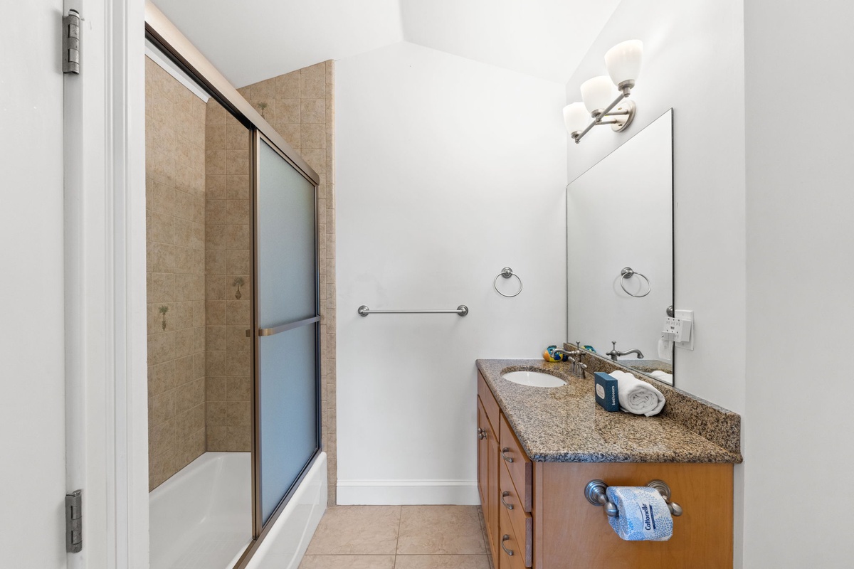 A well-appointed bathroom awaits you, featuring a spacious walk-in shower, modern fixtures, and ample vanity space for your daily routine.