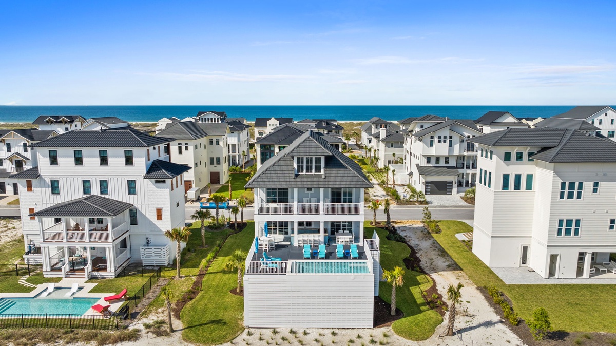 Beachfront vacation rental community offering direct access to sandy shores and ocean views. The property features a private pool and spacious outdoor areas within a coastal neighborhood setting.