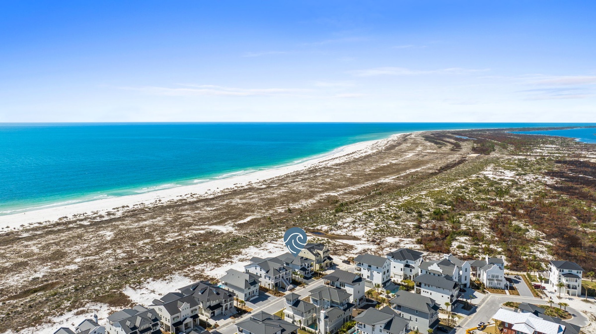 Stunning coastal development surrounded by pristine beaches and turquoise waters on a barrier island.