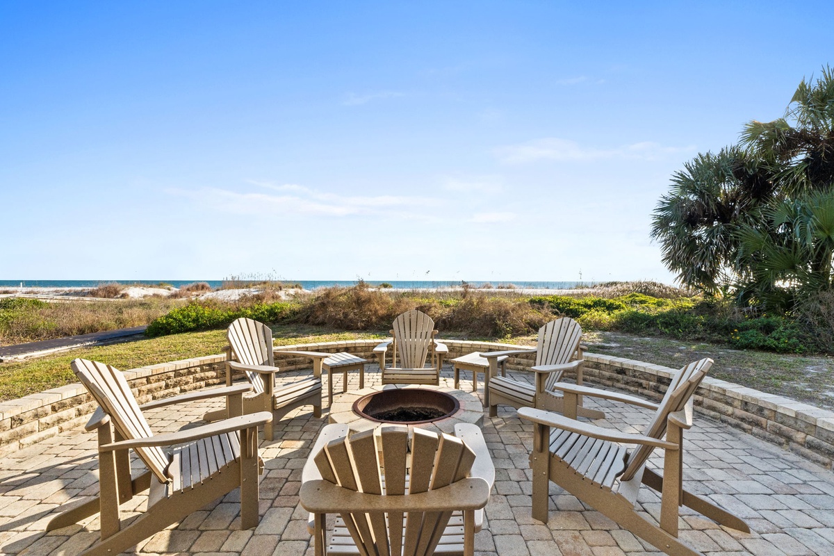Gather around the fire pit on your private patio, where ocean breezes and endless beach views create perfect evenings under the stars.