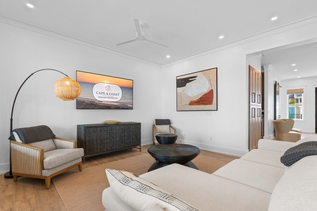 Settle into this elegant living room where coastal charm meets modern comfort. Sink into plush seating, enjoy the warm glow of designer lighting, and let the tranquil atmosphere welcome you home.