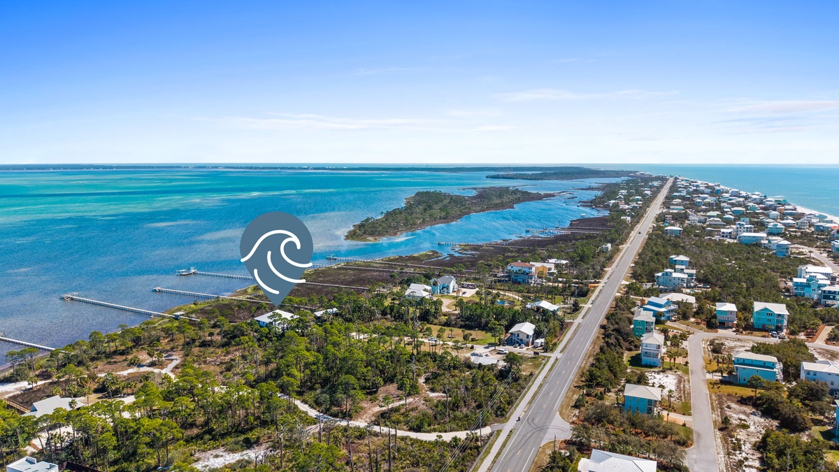 Aerial view of tropical coastal community featuring pristine turquoise waters, residential neighborhoods, and waterfront access.