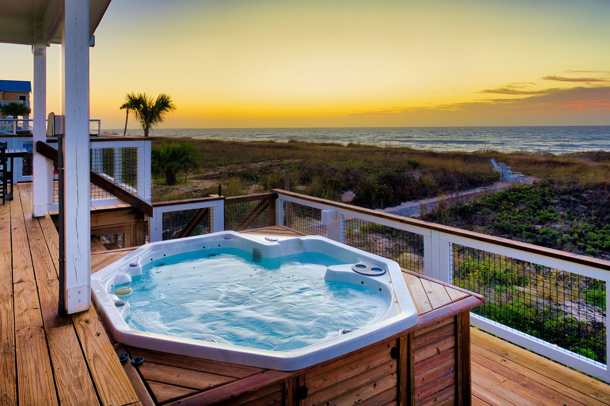 Unwind in your private hot tub as golden sunset paints the sky, with ocean waves just steps away from your deck.