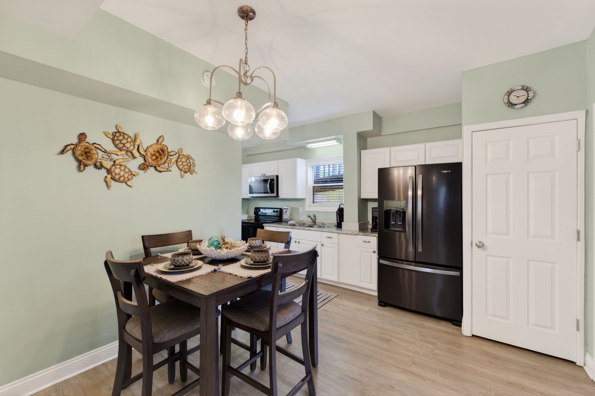 Gather around your stylish dining table under charming pendant lights, with a fully equipped kitchen ready for your culinary adventures.