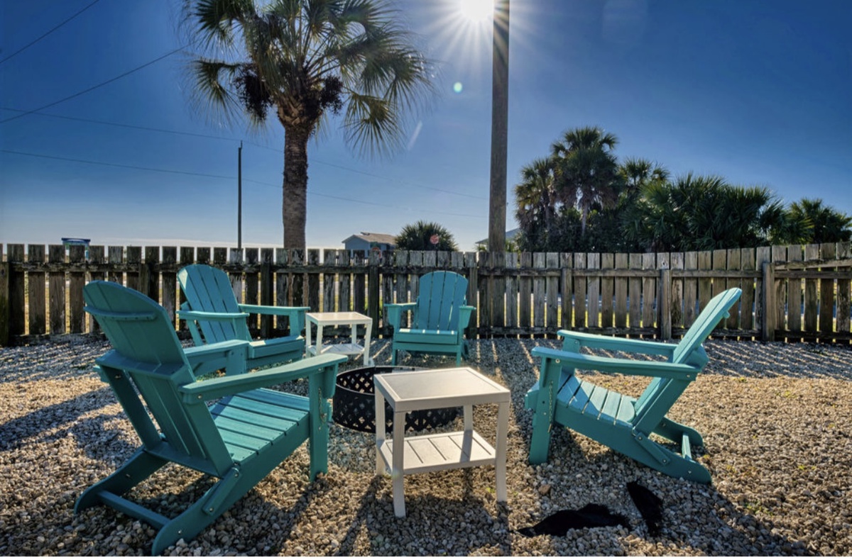 A cozy fire pit seating area provides a great spot to gather and enjoy cool coastal evenings.
