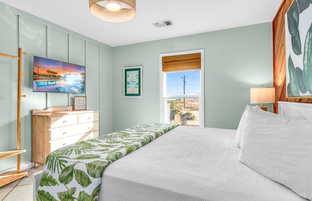 Drift off to sleep in your tropical paradise bedroom with soothing sage walls, warm wood furnishings, and peaceful views.