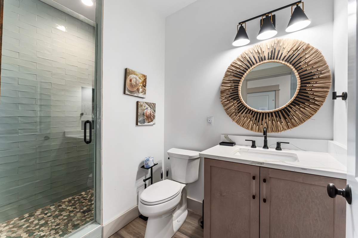 Your private bathroom blends modern comfort with coastal charm, featuring elegant fixtures and soothing touches for your daily rituals.
