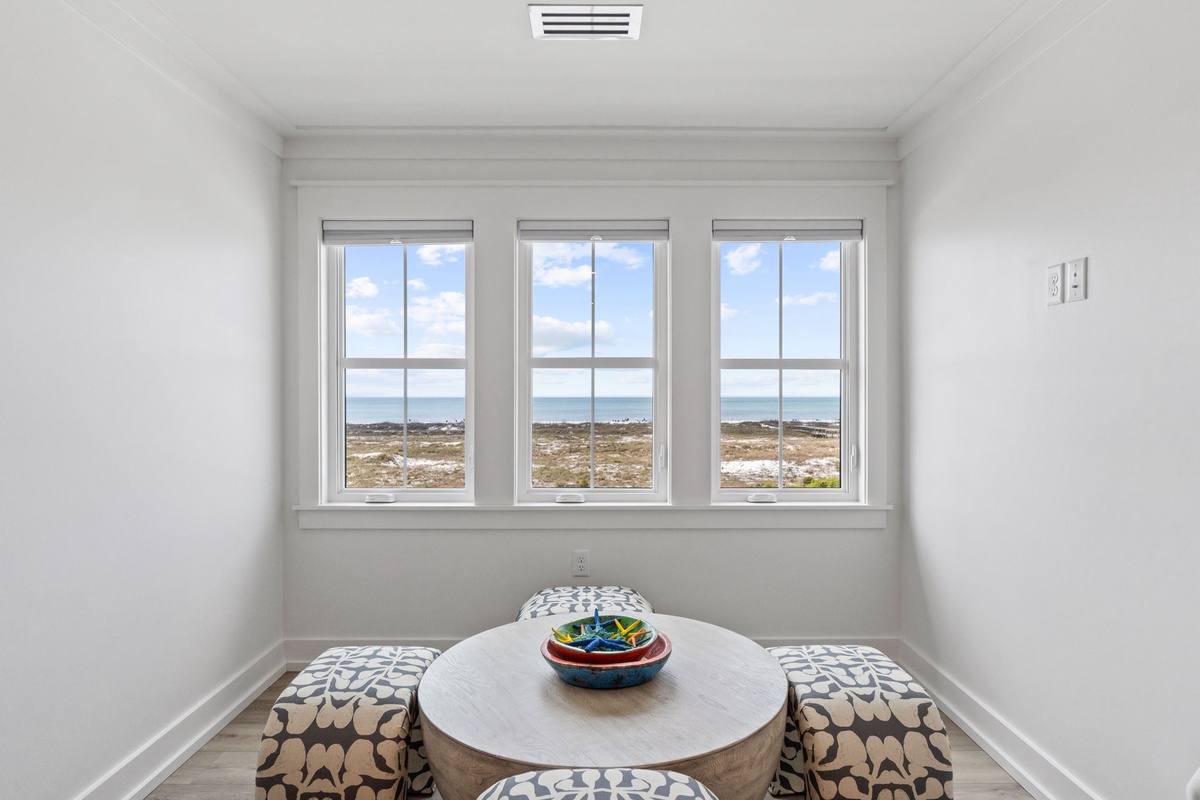 Your bright breakfast nook features stunning panoramic views through triple windows, perfect for morning coffee while watching the landscape unfold.