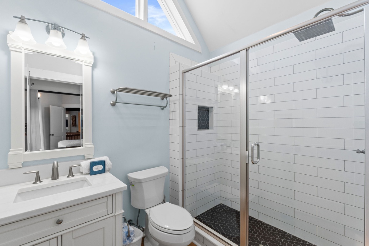 Step into your bright, airy bathroom with soaring vaulted ceilings and skylights that fill the space with natural light. Fresh white subway tile and a spacious walk-in shower invite you to refresh after your adventures.