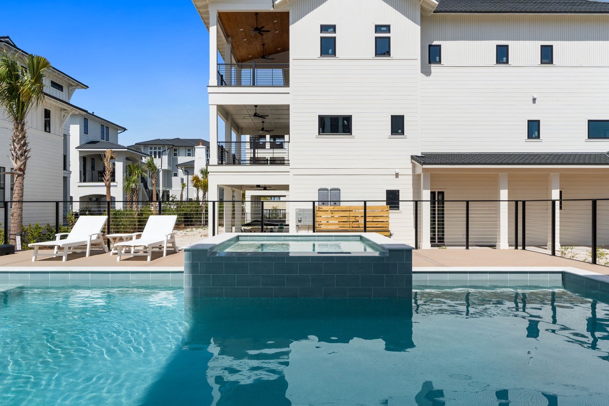 Stunning resort-style pool with hot tub where your vacation days begin with refreshing swims under endless blue skies.