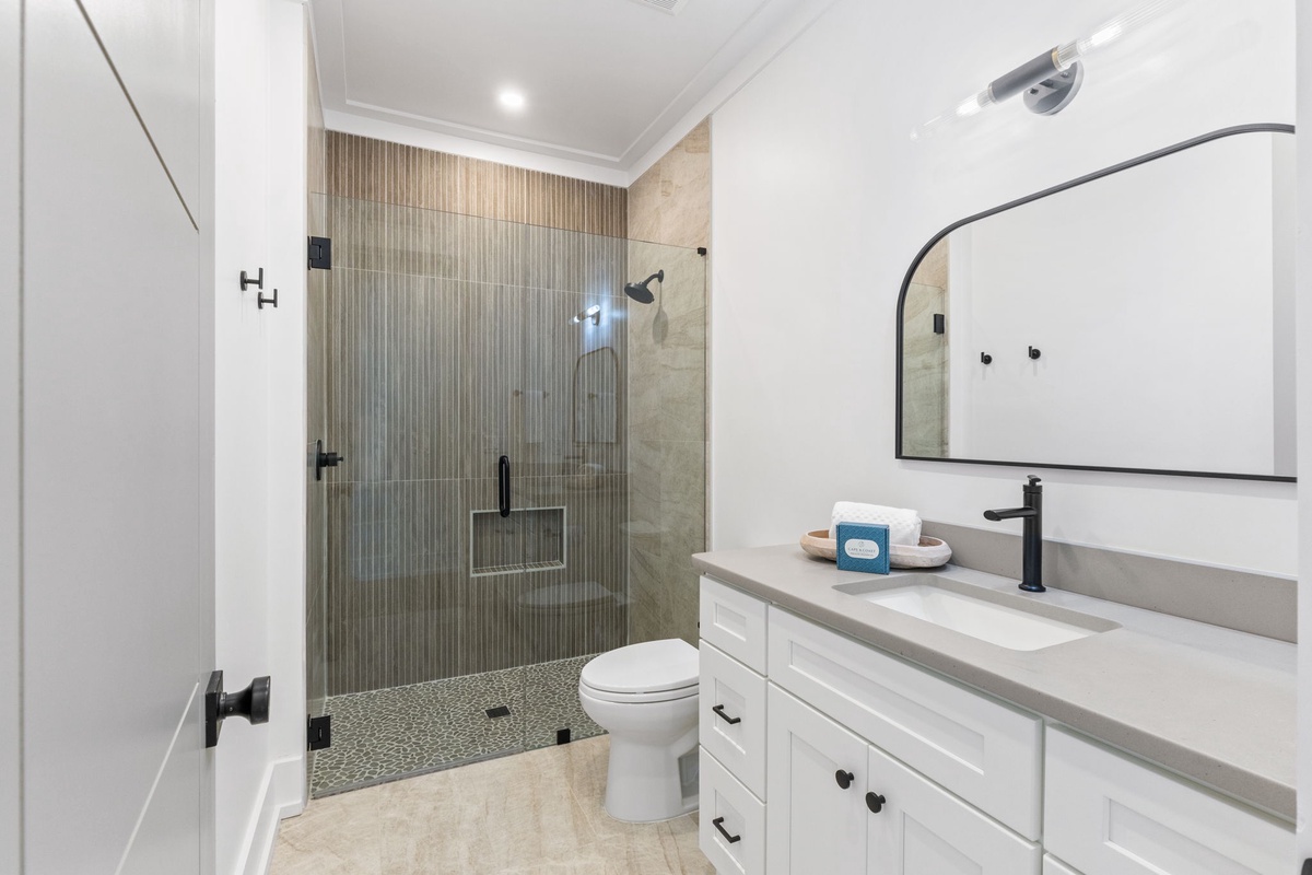 Unwind in your spa-like bathroom featuring a luxurious walk-in shower with stunning tilework and modern fixtures.