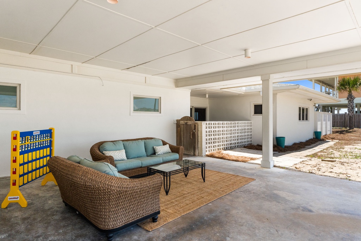 Relax in your own shaded outdoor lounge complete with comfy seating, a Connect Four game, and direct access to the sunny backyard—perfect for easy indoor-outdoor living.