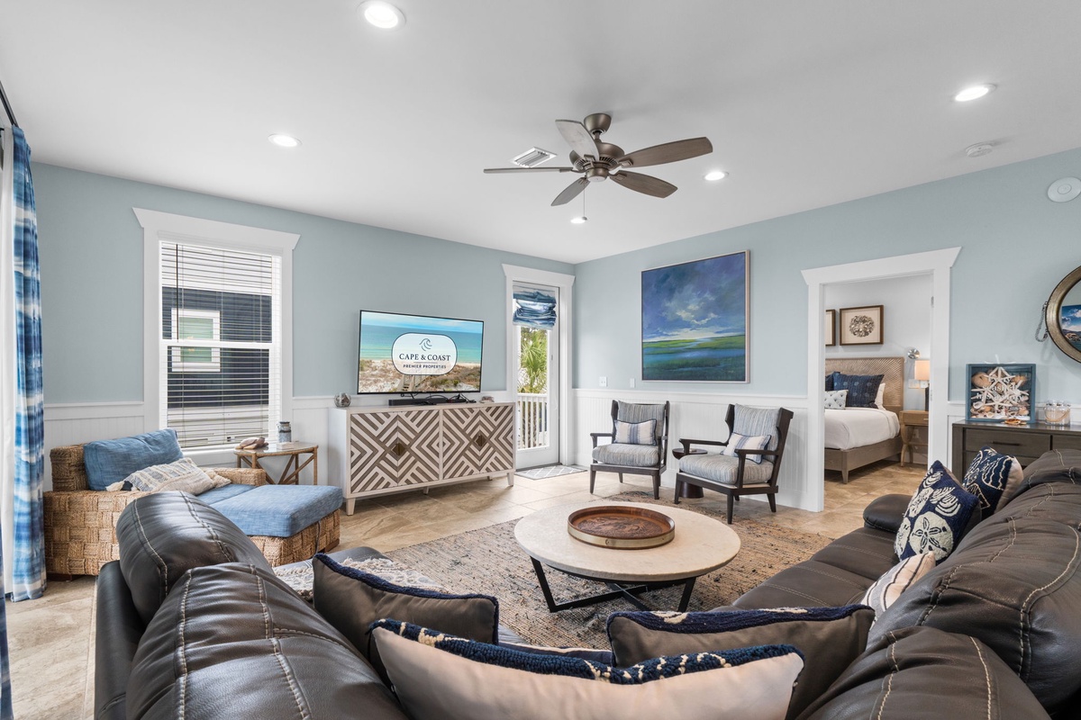 Picture yourself relaxing in this bright, coastal-inspired living room, where soft blues meet comfortable seating. Watch your favorite shows or unwind with loved ones in this airy, inviting space.