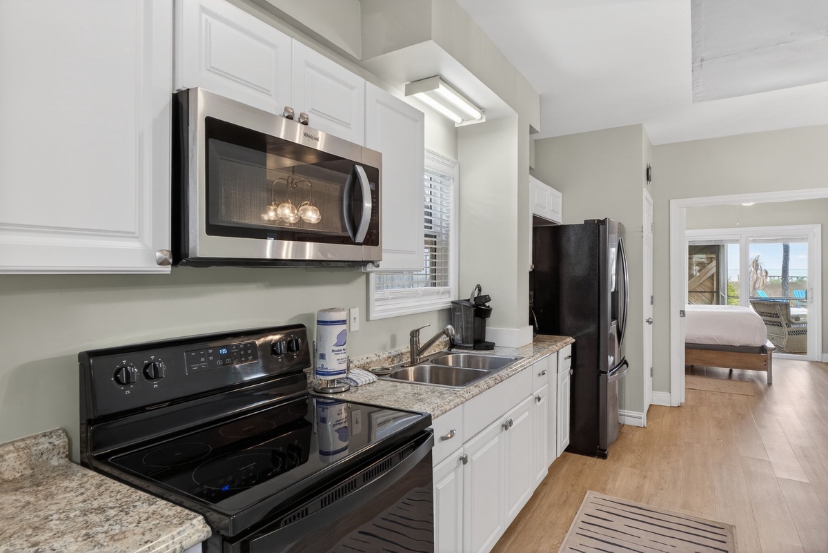 Your fully equipped kitchen features stainless steel appliances, granite countertops, and crisp white cabinetry for memorable meal prep.