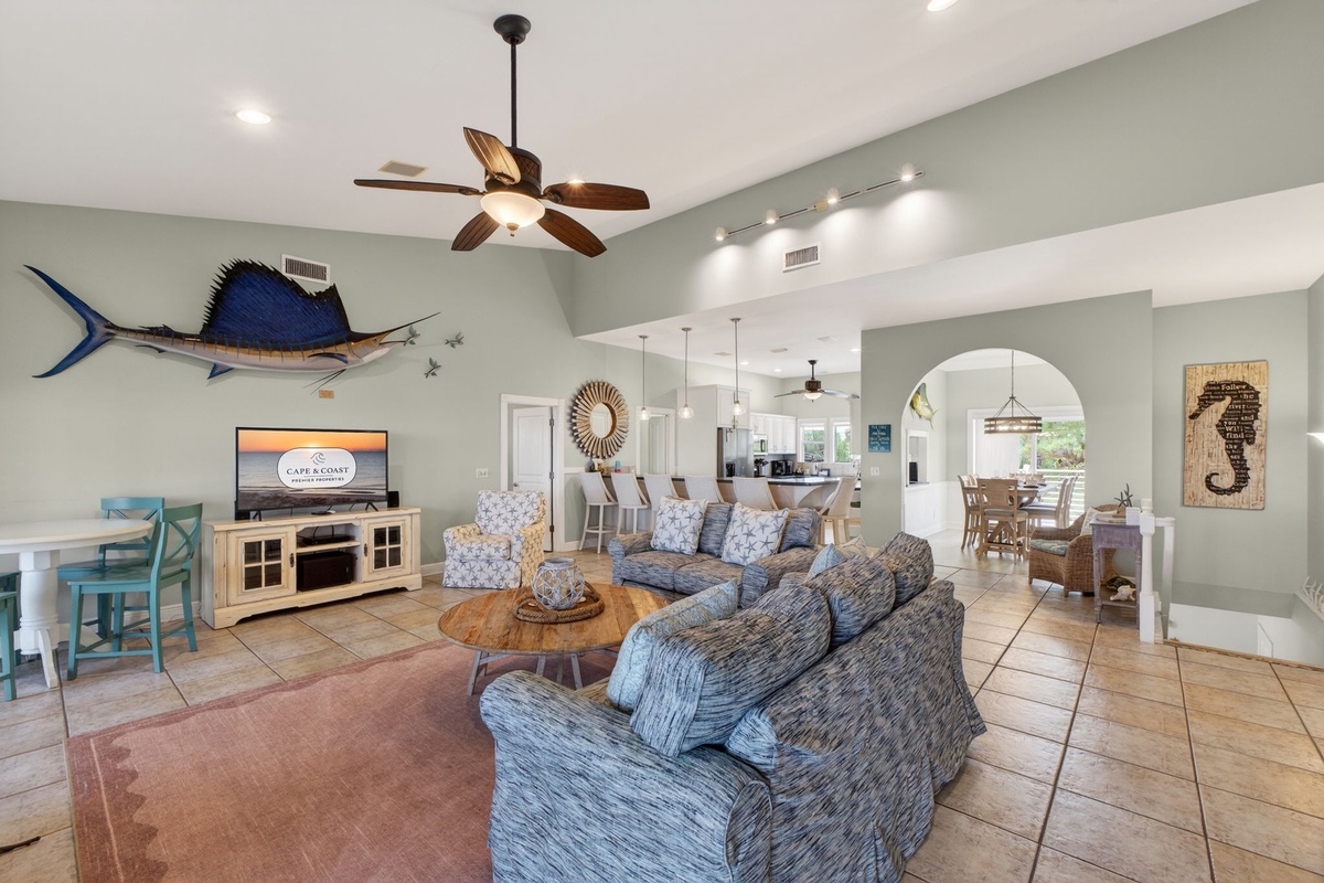 Your spacious coastal retreat flows seamlessly with open-concept living, where nautical touches and comfortable seating create the perfect atmosphere for gathering.