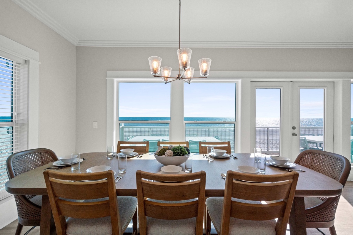 Gather around this elegant dining table where every meal becomes a celebration with stunning ocean views as your backdrop.