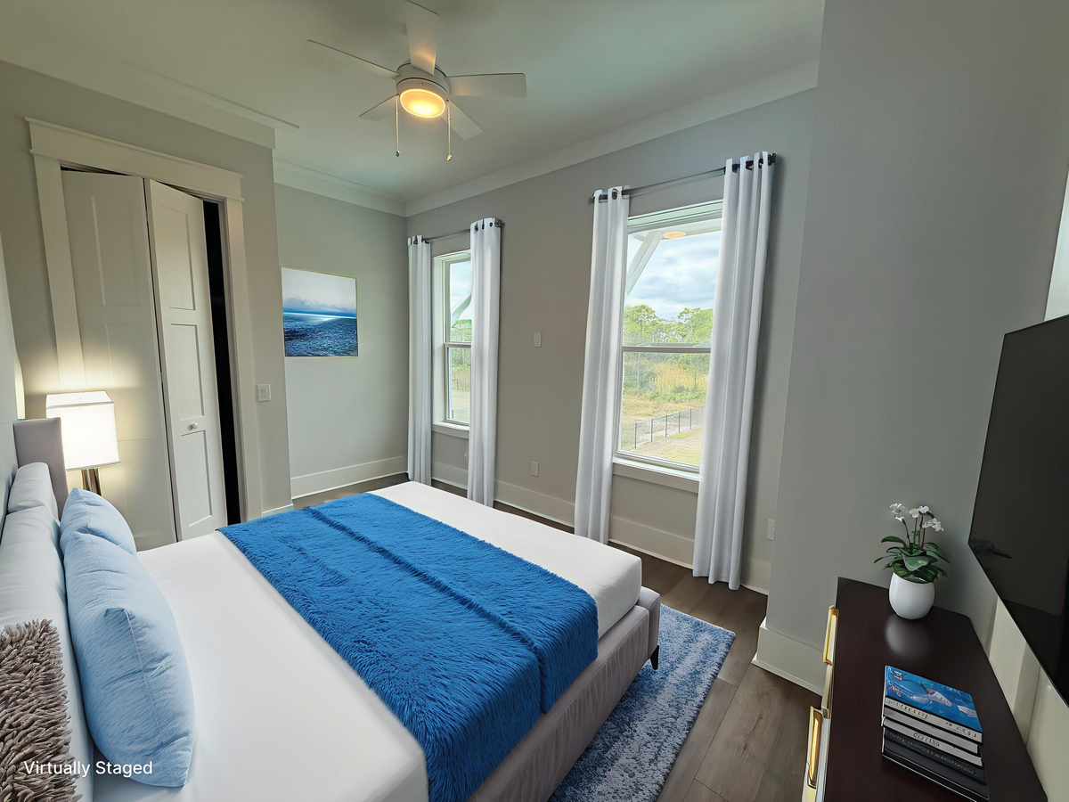 Drift off peacefully in your stylish bedroom with ocean-blue accents and natural light streaming through generous windows.