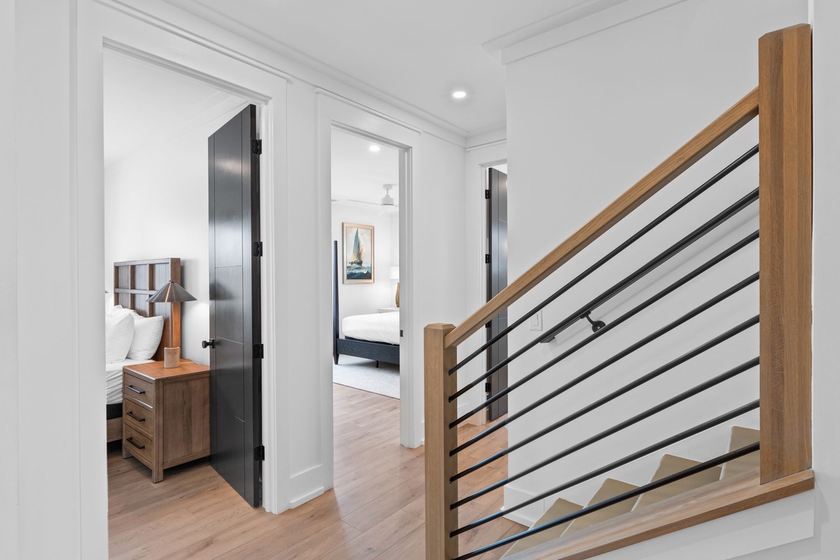 Step into a bright, thoughtfully designed space where warm wood tones and modern railings guide you to inviting bedrooms, each crafted for your comfort and tranquility.