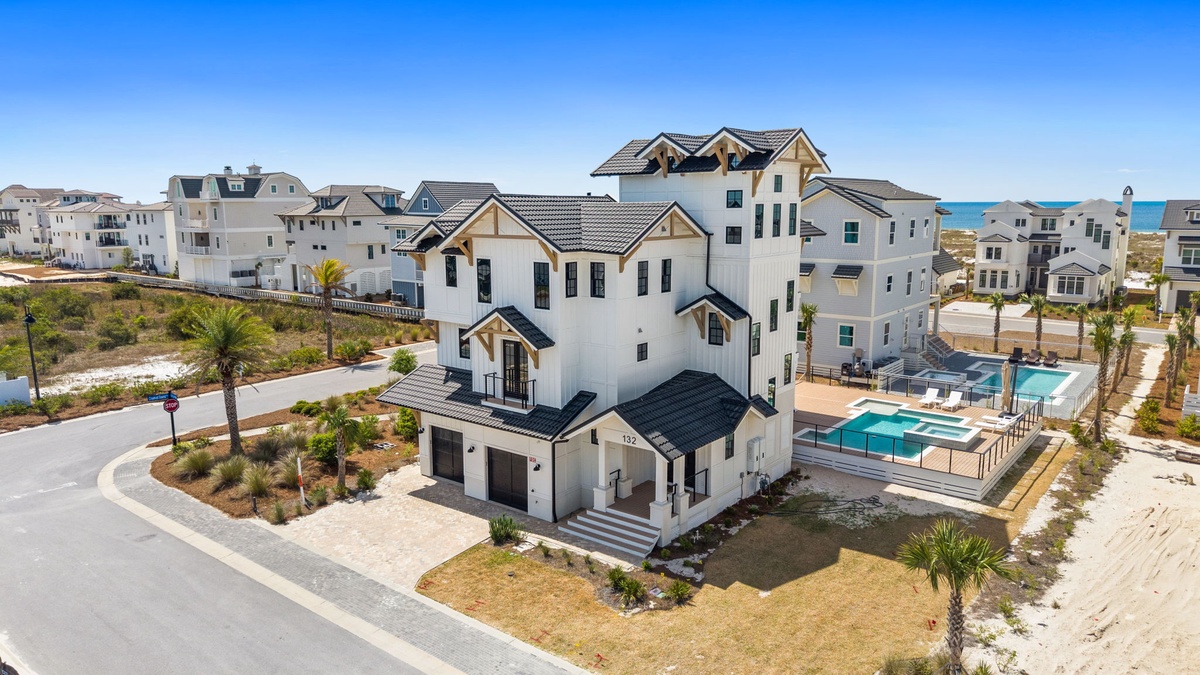 Stunning beachside property featuring elegant architecture and private pool in an exclusive coastal neighborhood.