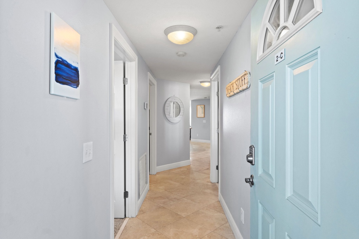 Step into your bright, welcoming hallway where coastal colors and thoughtful touches create an instant sense of home away from home.