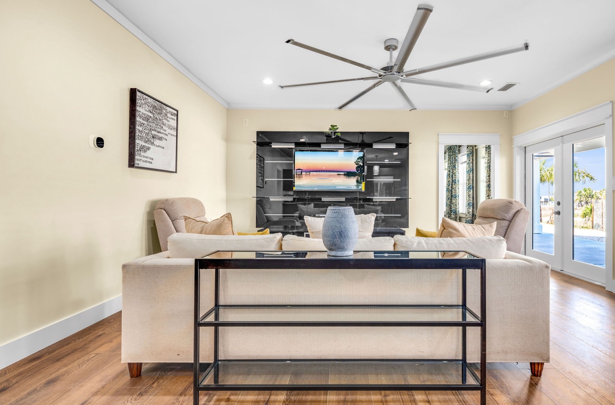 Sink into plush seating while enjoying your favorite shows on the large smart TV in this bright, airy living space.