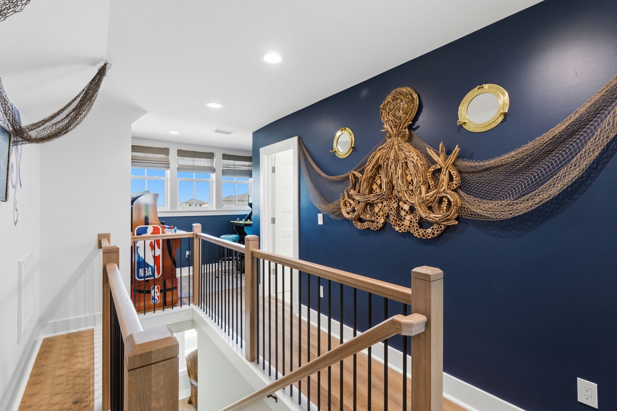 Nautical charm meets coastal elegance in this striking hallway, where a handcrafted rope octopus and fishing nets set a relaxed, seaside tone as you move through your home.
