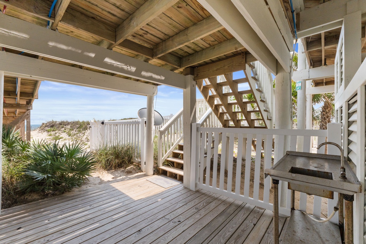Steps away from the beach, this covered deck offers your perfect coastal retreat with partial ocean views and soft breezes drifting through.