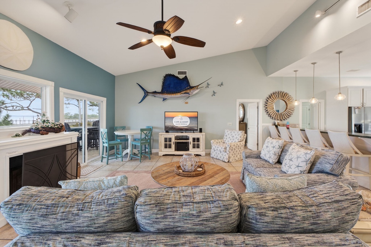 Sink into plush coastal comfort where your family gathers around the fireplace, ocean breezes flow through open spaces, and every detail invites relaxation.