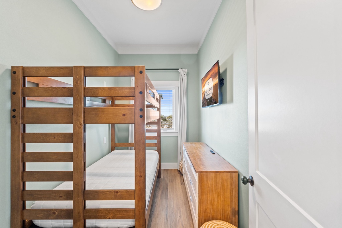Your comfortable bunk bed room features warm wood furnishings, soothing mint walls, and plenty of space to unwind after your adventures.