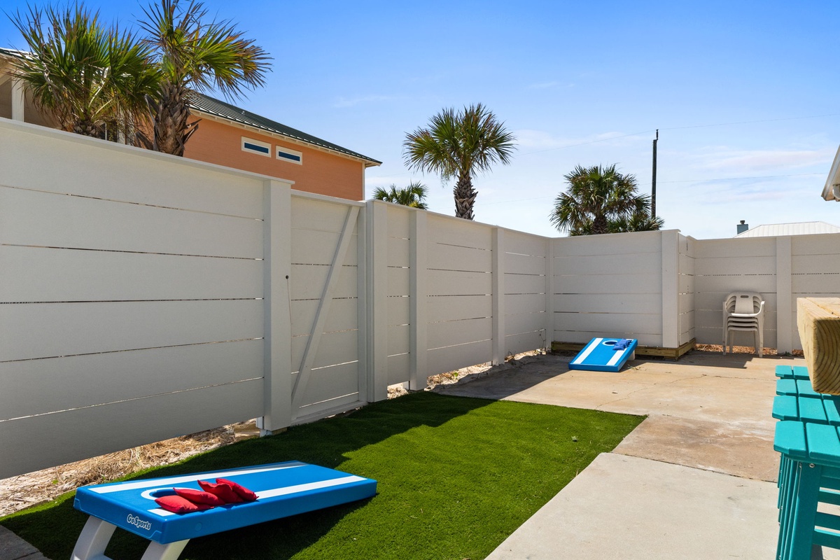 This private outdoor space offers a fun yard for games, lush artificial turf for relaxation, and a peaceful backdrop of swaying palms—your own coastal retreat.