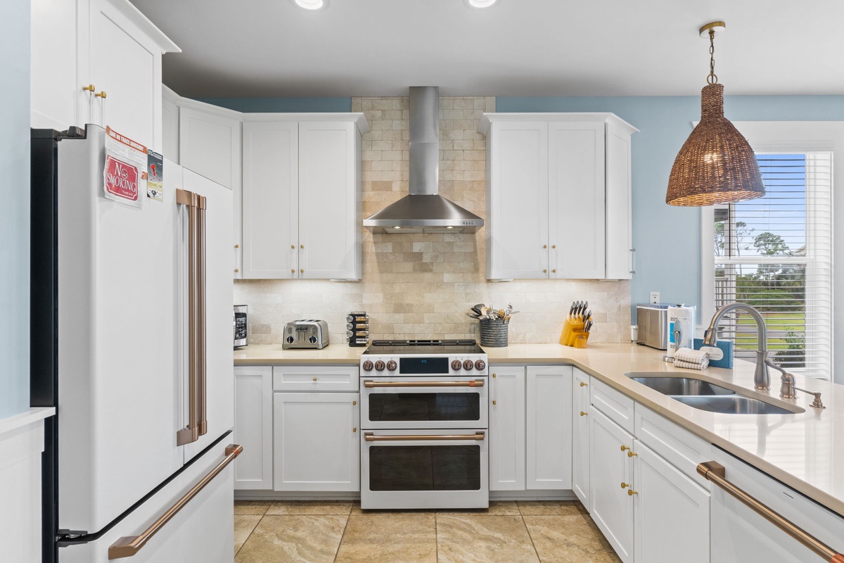 Gather around your fully equipped kitchen, where sleek countertops and modern appliances invite you to craft memorable meals together. Natural light streams in, warming the space as you cook.