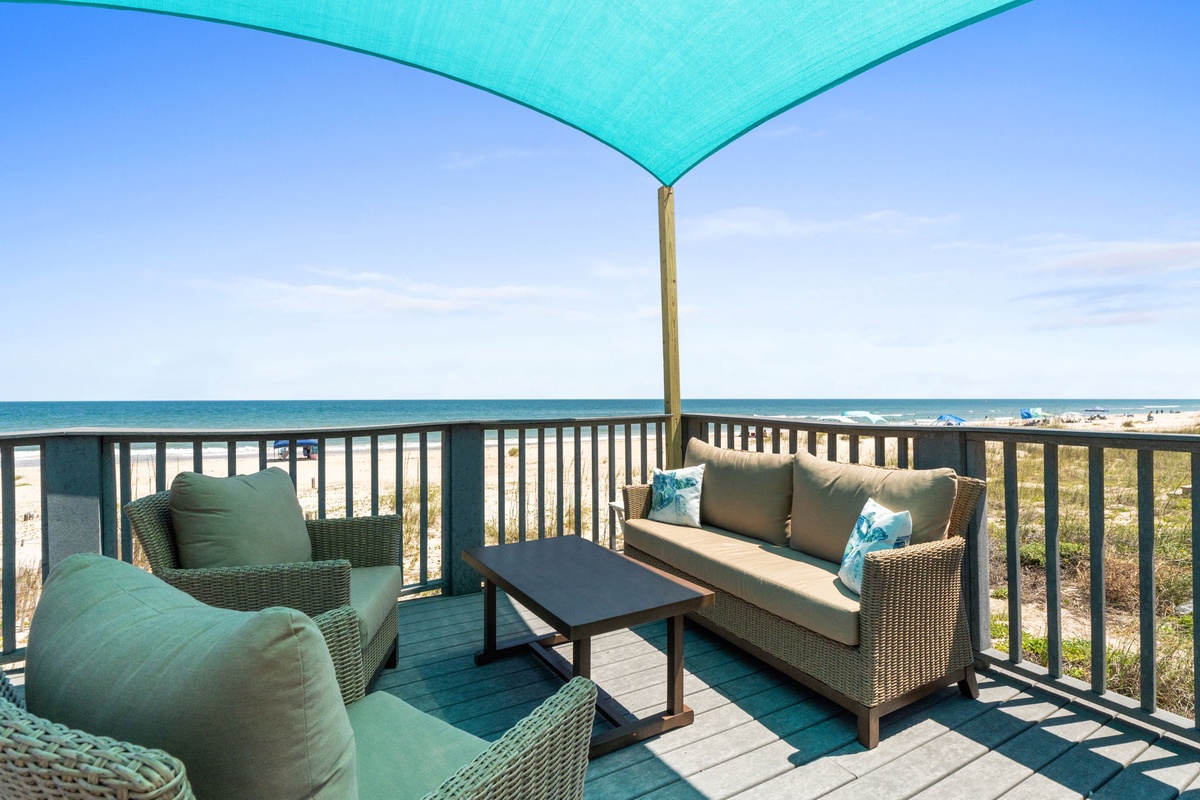 Your private beachfront deck offers plush seating and shade, where you can sip morning coffee while listening to waves just steps from the sand.