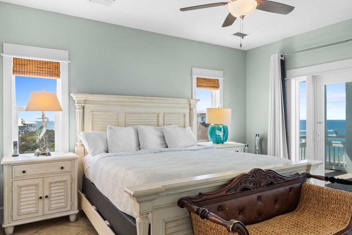 Wake up to stunning ocean views in your serene coastal bedroom with soft sea-green walls and elegant furnishings.