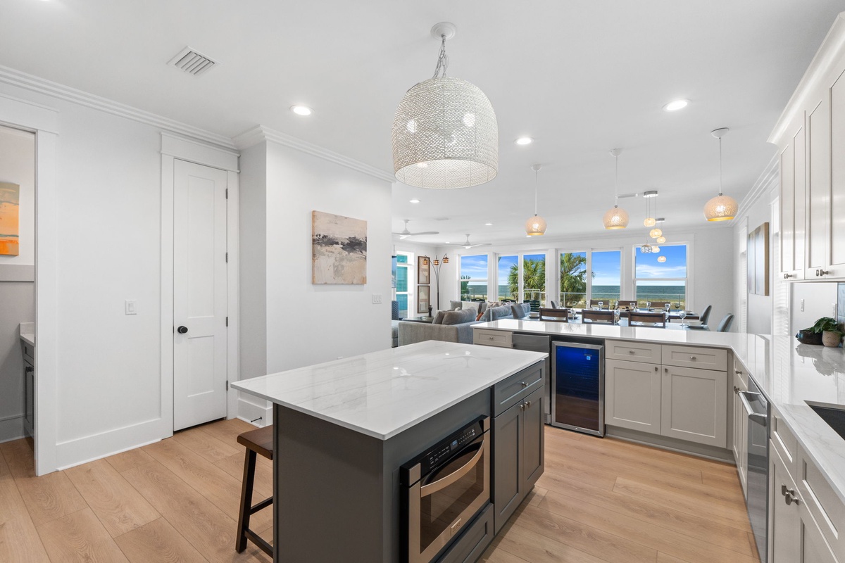 Your gourmet kitchen invites culinary adventures with its marble island, modern appliances, and stunning ocean views that bring the coast into every meal.
