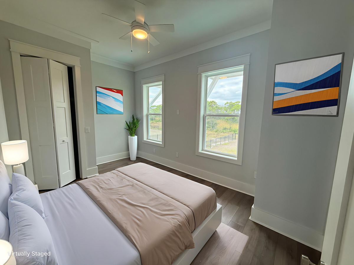 Wake up to natural light flooding your peaceful bedroom, where colorful artwork and garden views create the perfect retreat for restful nights.