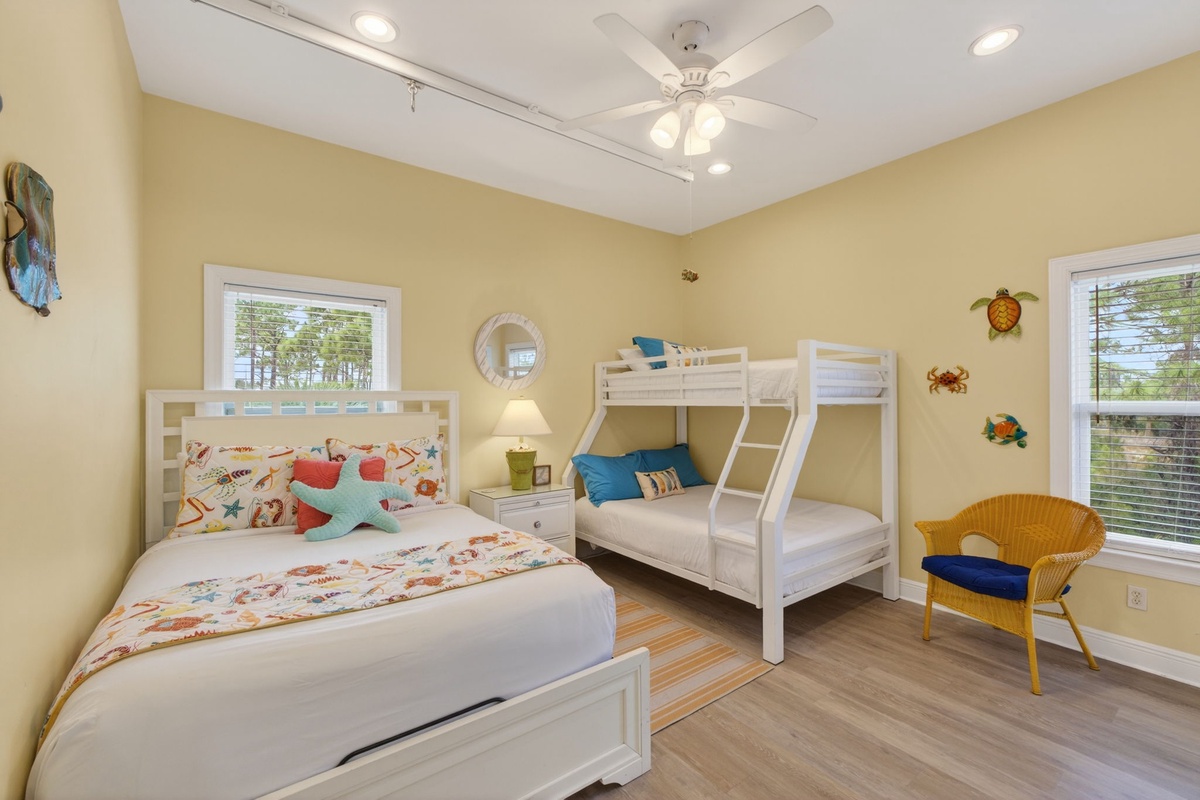 Relax in your cheerful beach-themed bedroom with comfortable beds, tropical touches, and sunny yellow walls that create a coastal getaway feel.