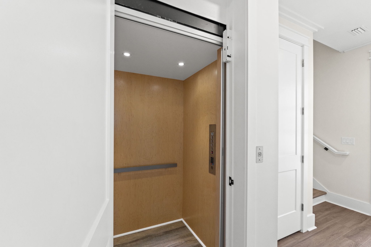 Modern elevator provides easy access throughout your vacation home, combining convenience with sleek contemporary design.