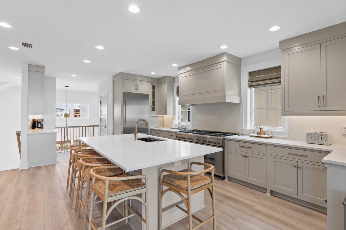 Your spacious chef's kitchen features gleaming quartz counters, professional-grade appliances, and a generous island where you'll love preparing meals and gathering with loved ones.