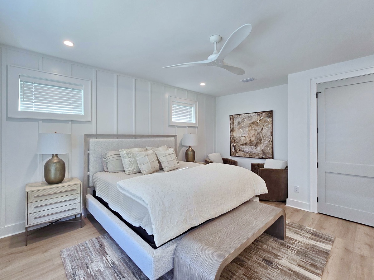 Sink into this serene bedroom where soft linens and gentle lighting create your perfect retreat.