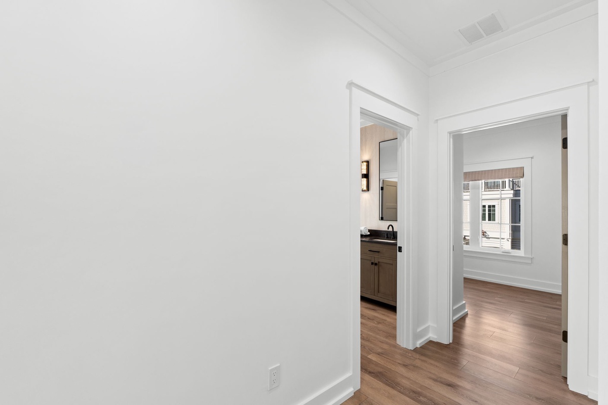 Your bright, open living space flows seamlessly with rich hardwood floors and clean white walls throughout.