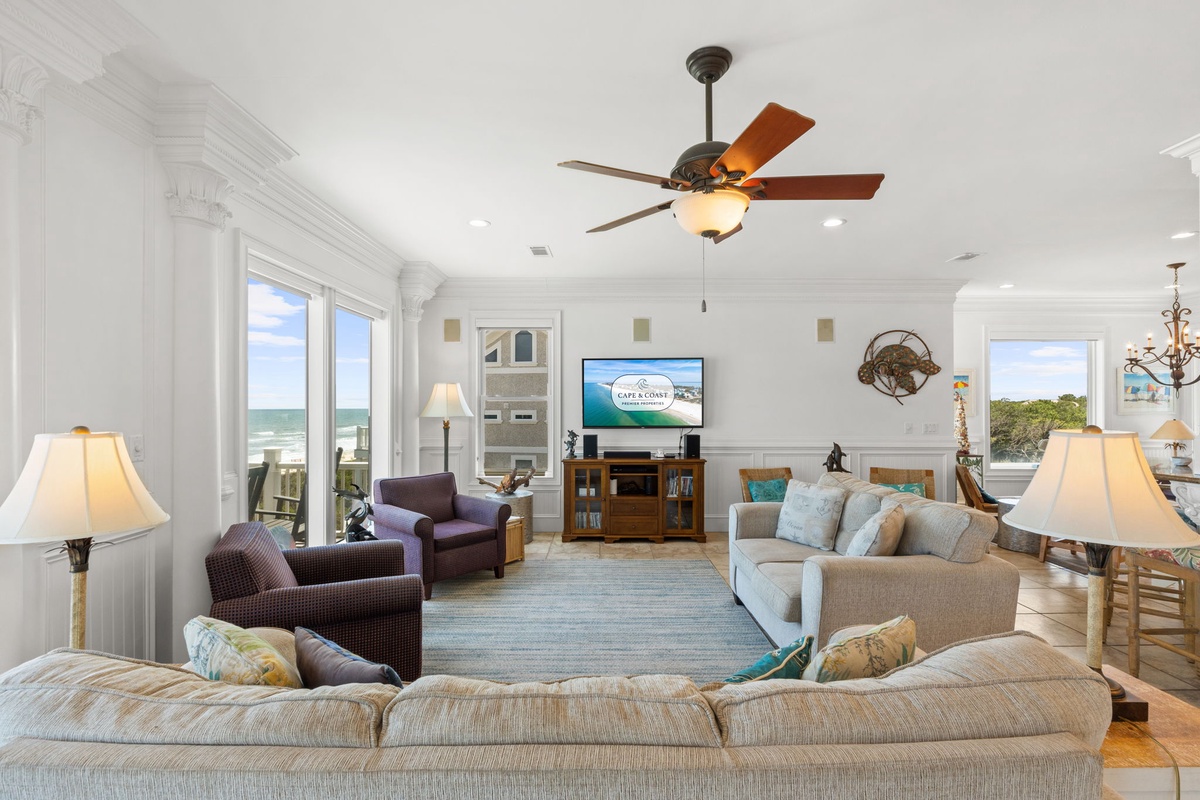 Picture yourself unwinding in this airy, sun-drenched living room with stunning ocean views framing every moment. Plush seating invites you to relax while waves whisper just beyond the windows.