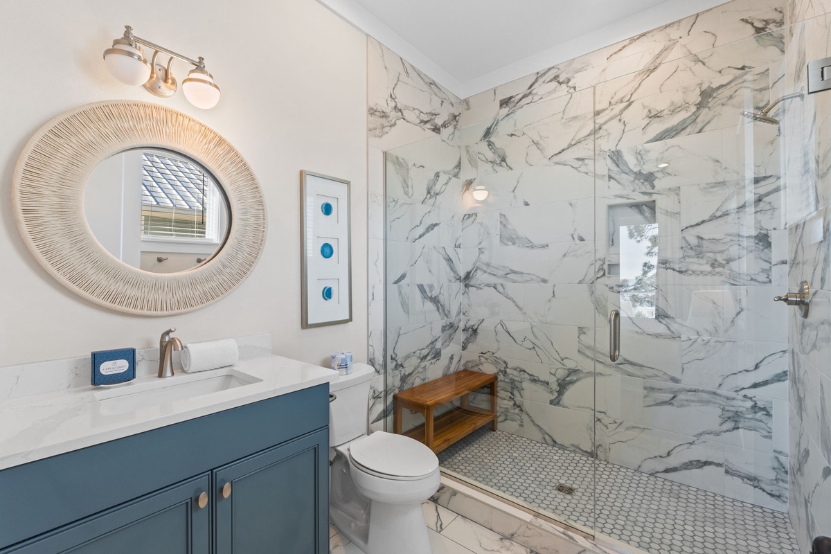 Your elegant bathroom features stunning marble walls and a spacious glass shower where you can unwind after your adventures.