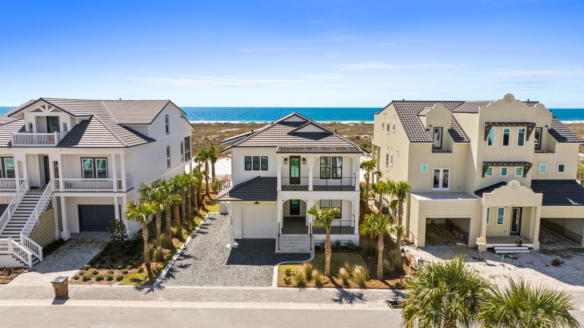 Coastal vacation home community features modern beach houses with ocean access and tropical landscaping just steps from pristine shoreline.